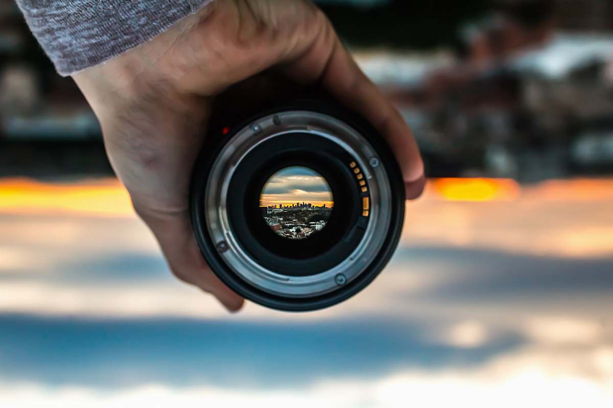 los angeles person holding black camera lens lens